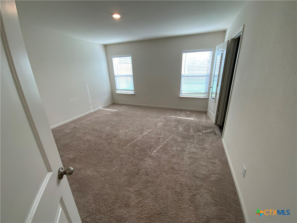 208 Allington Circle Jarrell, TX 76537 - Photo 7 of 16 an empty room with windows and closet