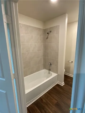 a bathroom with a bathtub and a sink
