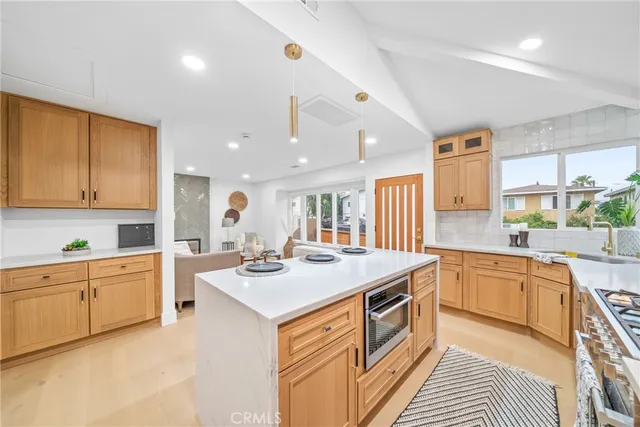a kitchen with stainless steel appliances granite countertop a stove and a sink