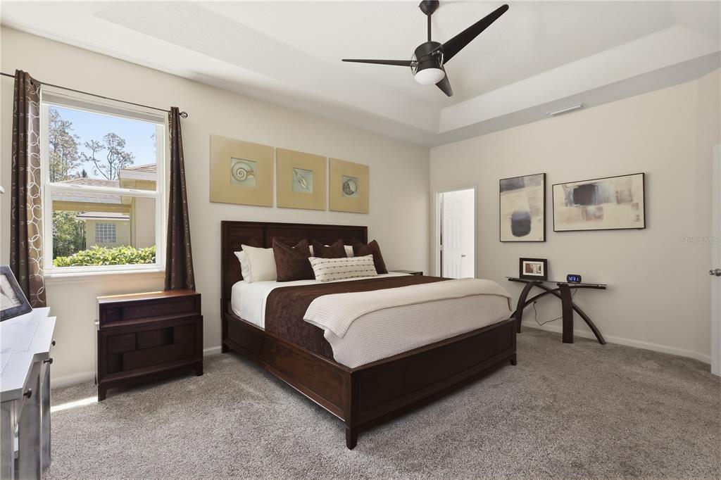 124 South Hummingbird Place Palm Coast, FL 32164 - Photo 14 of 47 a bedroom with a bed and a window