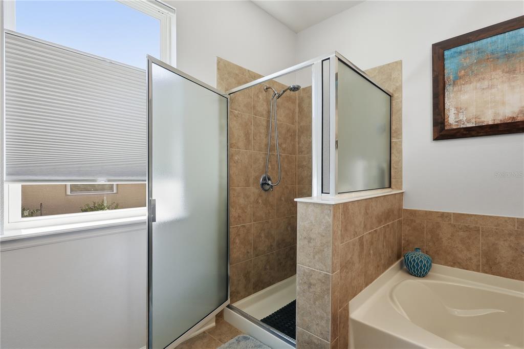 124 South Hummingbird Place Palm Coast, FL 32164 - Photo 16 of 47 a bathroom with a tub and shower