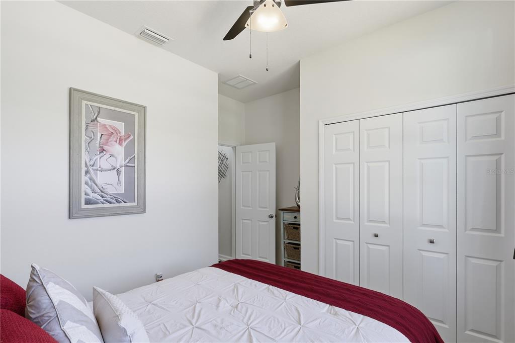 124 South Hummingbird Place Palm Coast, FL 32164 - Photo 19 of 47 a bedroom with a bed and a painting on the wall