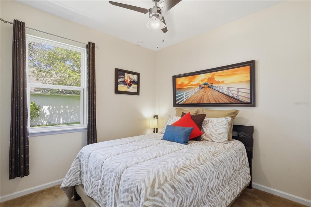 124 South Hummingbird Place Palm Coast, FL 32164 - Photo 20 of 47 a bedroom with a large bed and a window