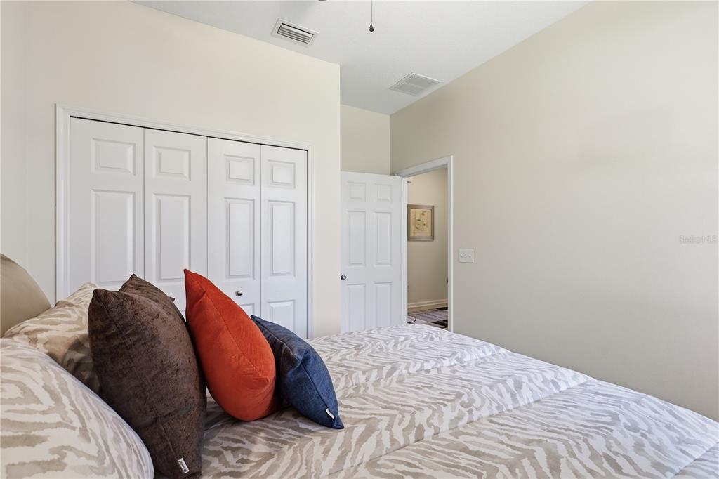 124 South Hummingbird Place Palm Coast, FL 32164 - Photo 21 of 47 a bedroom with a bed and a closet