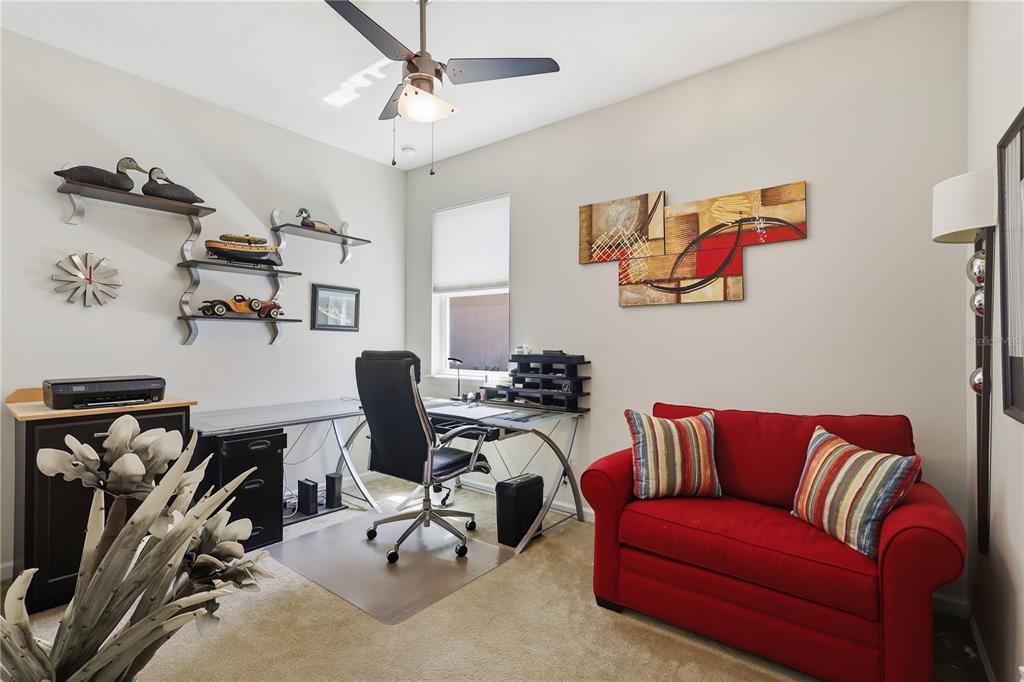 124 South Hummingbird Place Palm Coast, FL 32164 - Photo 22 of 47 a view of a livingroom with workspace and a couch