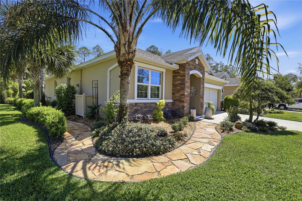 124 South Hummingbird Place Palm Coast, FL 32164 - Photo 43 of 47 a view of a house with a yard