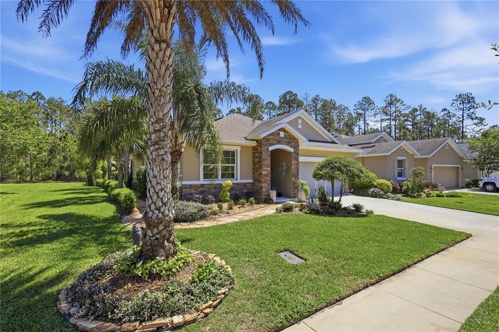 124 South Hummingbird Place Palm Coast, FL 32164 - Photo 45 of 47 a front view of a house with a yard