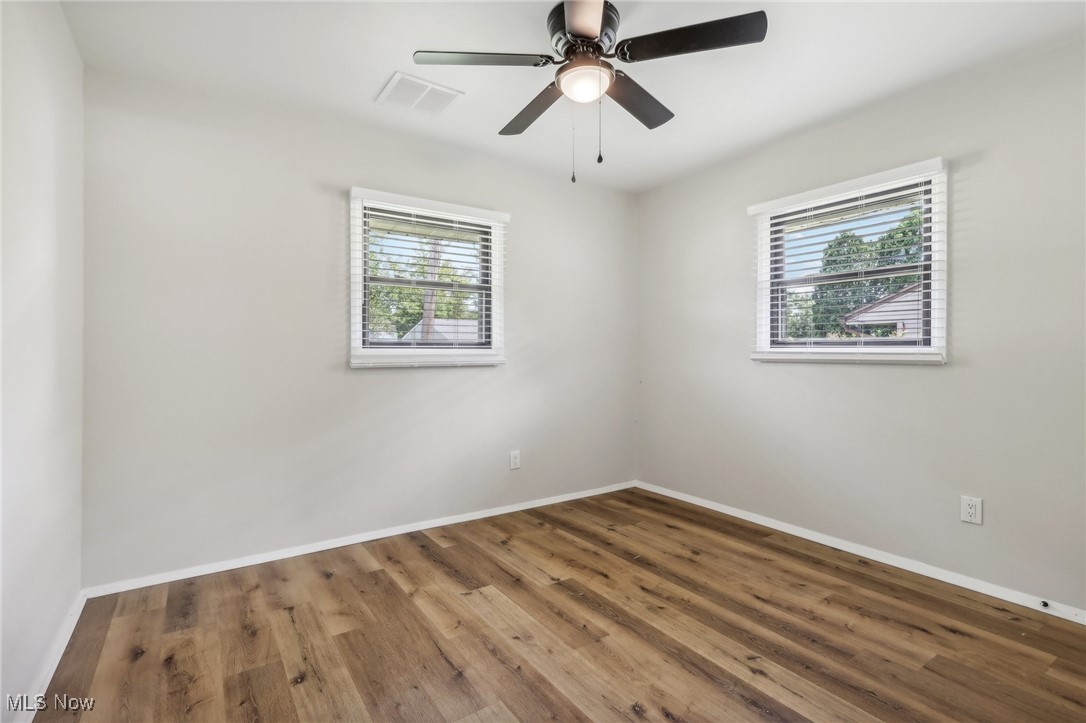 38 Rutledge Drive Youngstown, OH 44505 - Photo 14 of 32 Spare room with a wealth of natural light, visible vents, baseboards, and wood finished floors