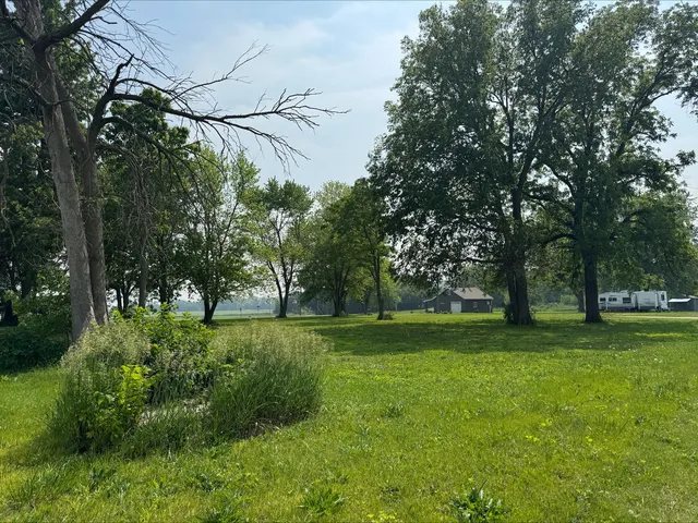 a big yard with lots of green space and trees