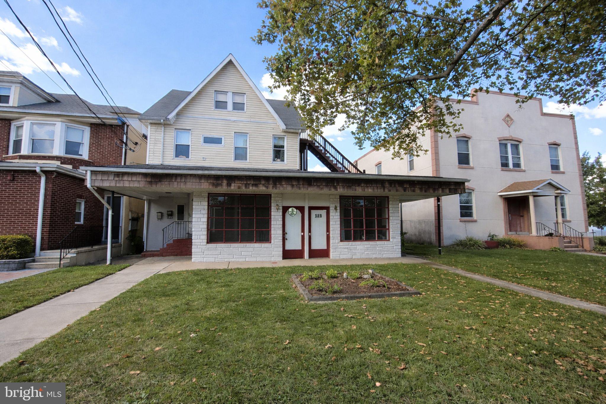 2 East Broad Street, Unit 2 Palmyra, NJ 08065 - Photo 1 of 15 a front view of a house with a garden and trees