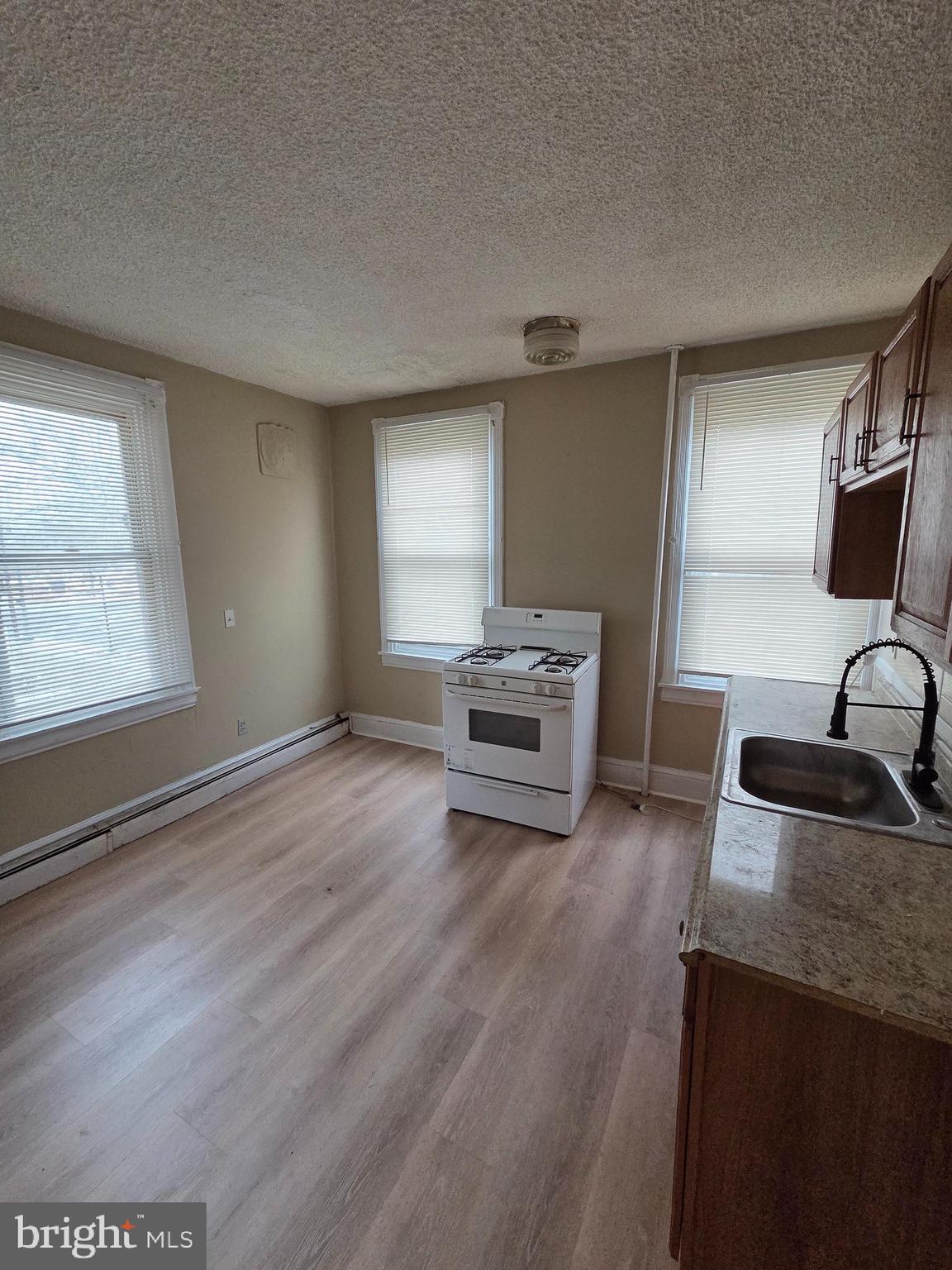 2 East Broad Street, Unit 2 Palmyra, NJ 08065 - Photo 11 of 15 a kitchen with granite countertop a sink and a stove top oven