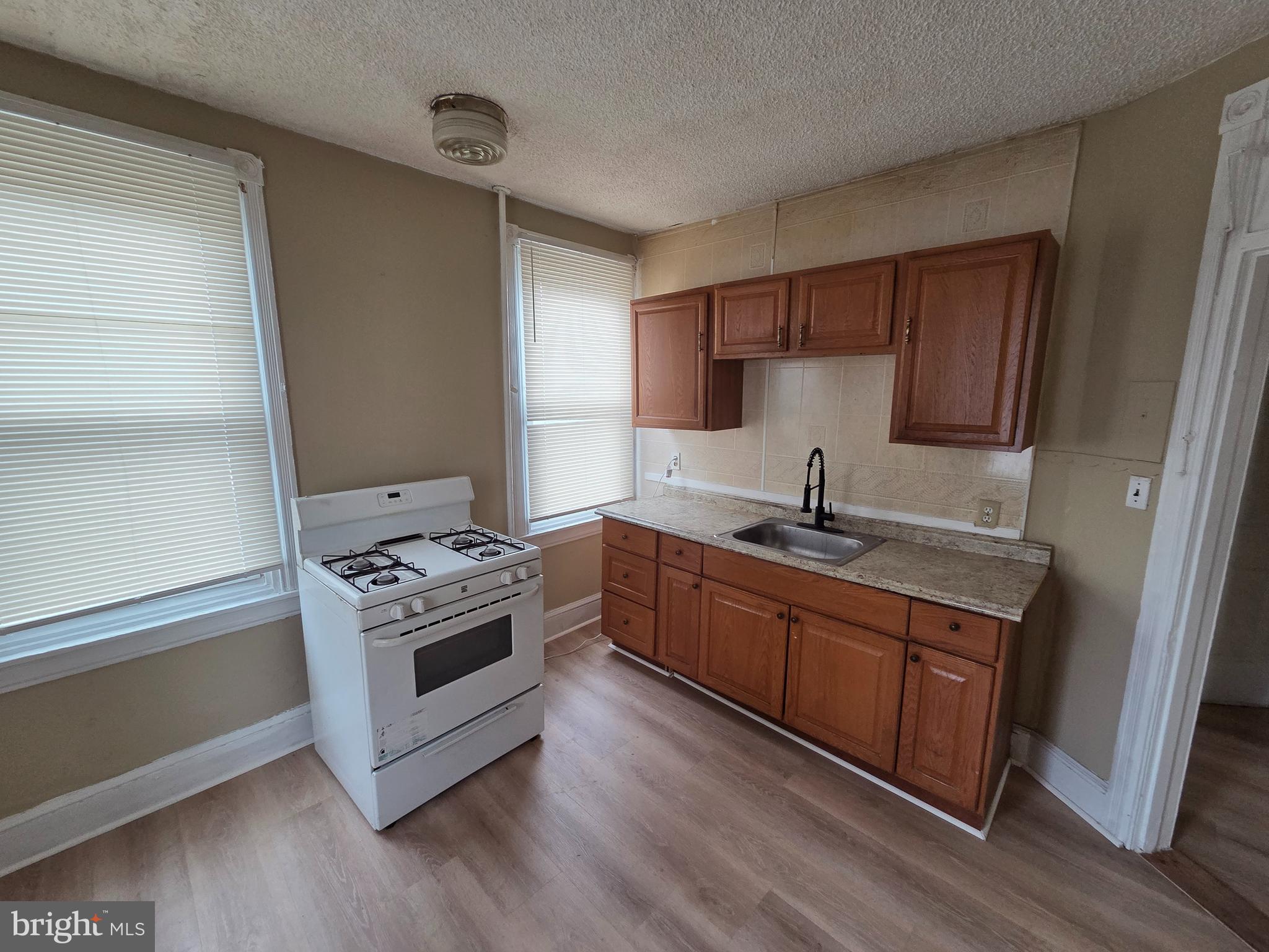 2 East Broad Street, Unit 2 Palmyra, NJ 08065 - Photo 4 of 15 a kitchen with stainless steel appliances granite countertop a sink stove and refrigerator