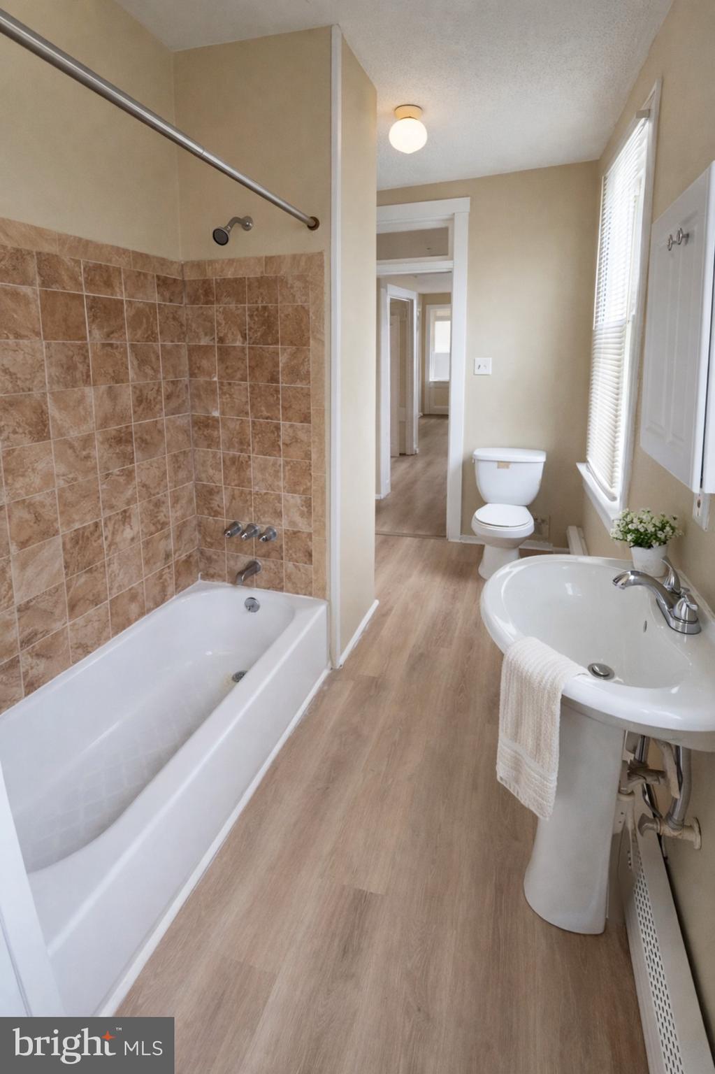 2 East Broad Street, Unit 2 Palmyra, NJ 08065 - Photo 5 of 15 a bathroom with a tub sink and mirror