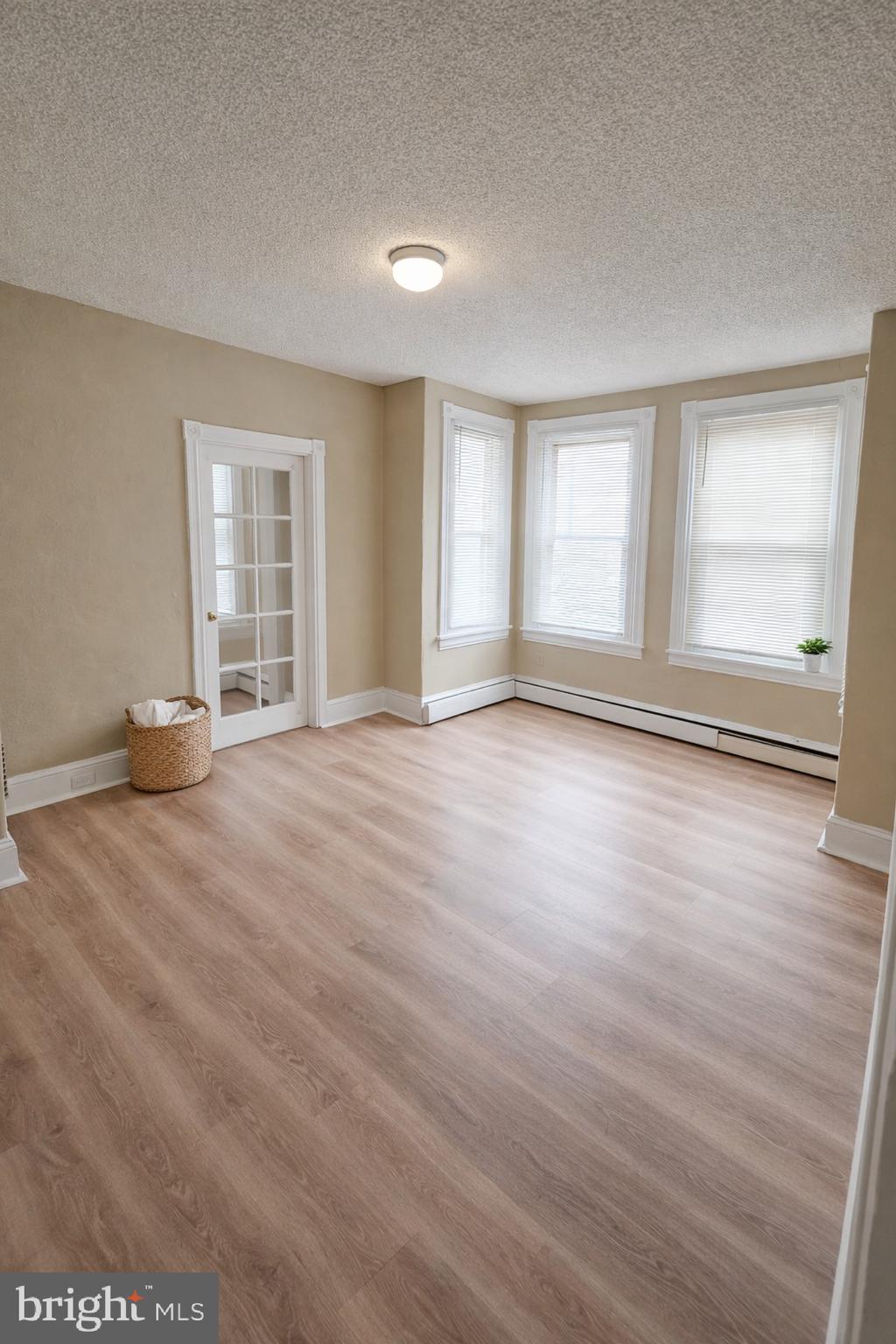 2 East Broad Street, Unit 2 Palmyra, NJ 08065 - Photo 6 of 15 an empty room with wooden floor and windows