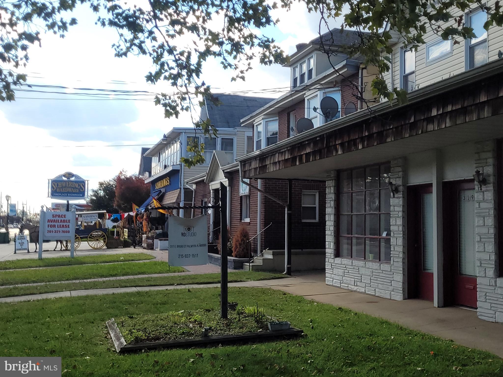 2 East Broad Street, Unit 2 Palmyra, NJ 08065 - Photo 10 of 15 a front view of a house with garden and trees