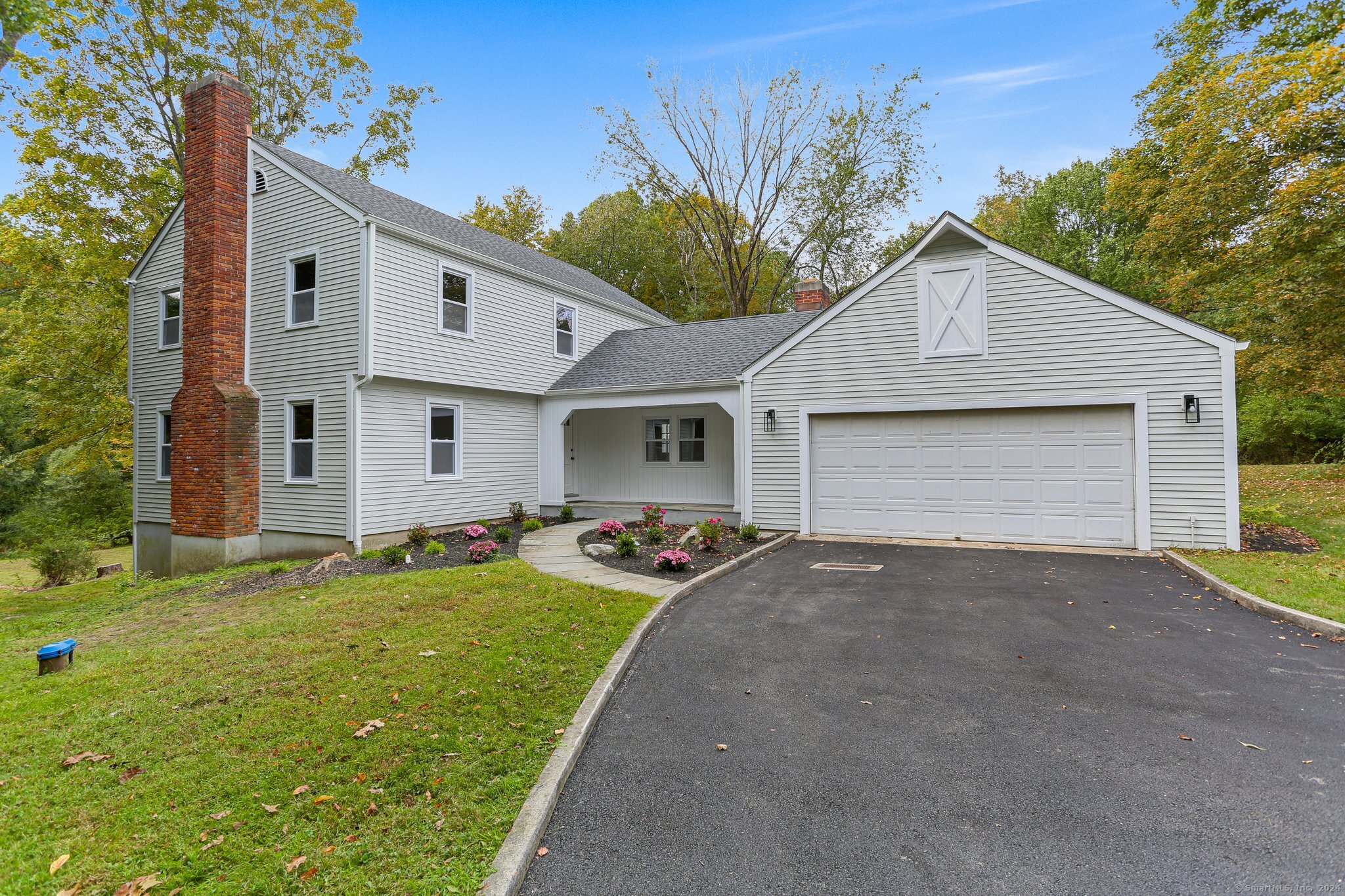 28 Kellogg Drive Wilton, CT 06897 - Photo 1 of 1 a front view of a house with a yard and garage