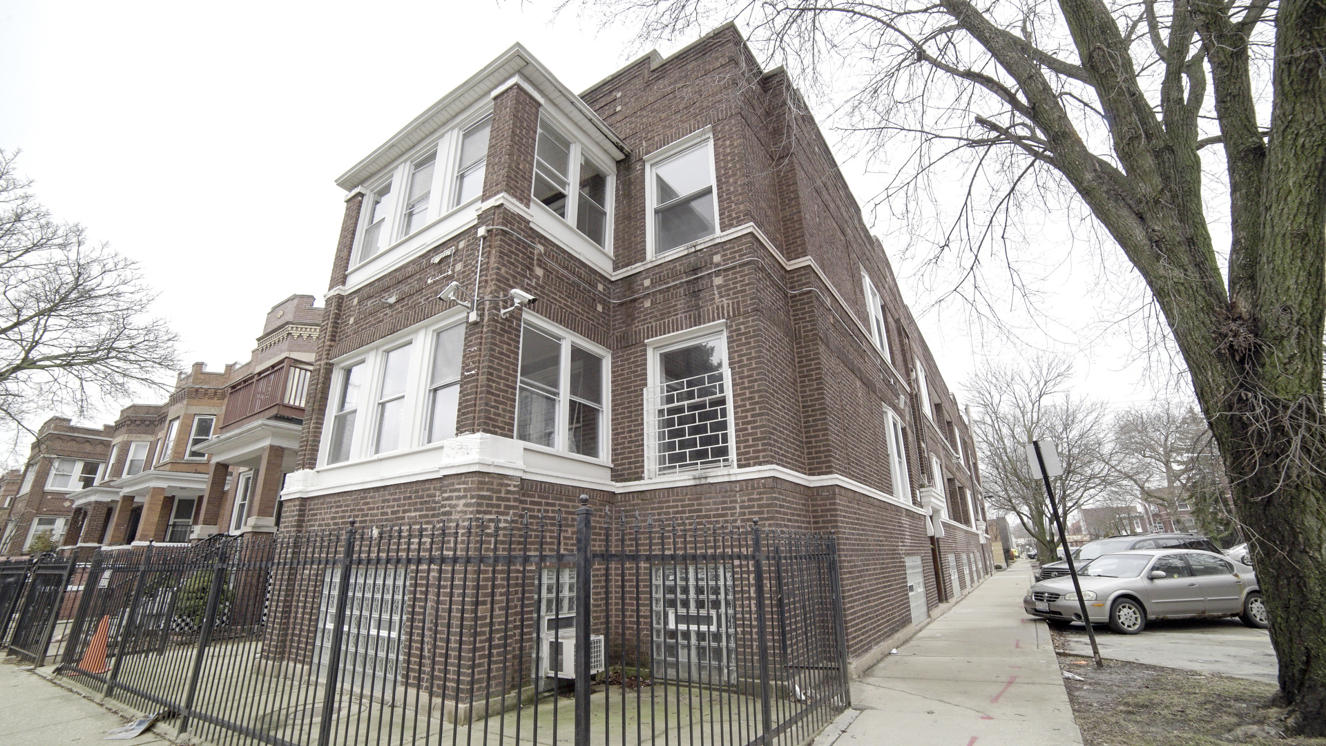 3903 West Belden Avenue, Unit 2 Chicago, IL 60647 - Photo 1 of 15 a front view of a residential apartment building with a yard