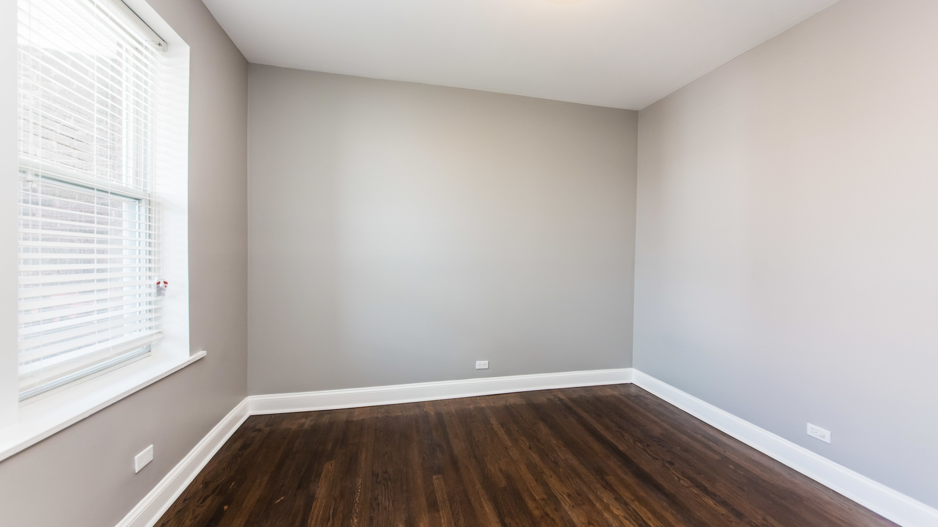 3903 West Belden Avenue, Unit 2 Chicago, IL 60647 - Photo 11 of 15 a view of an empty room with wooden floor and a window