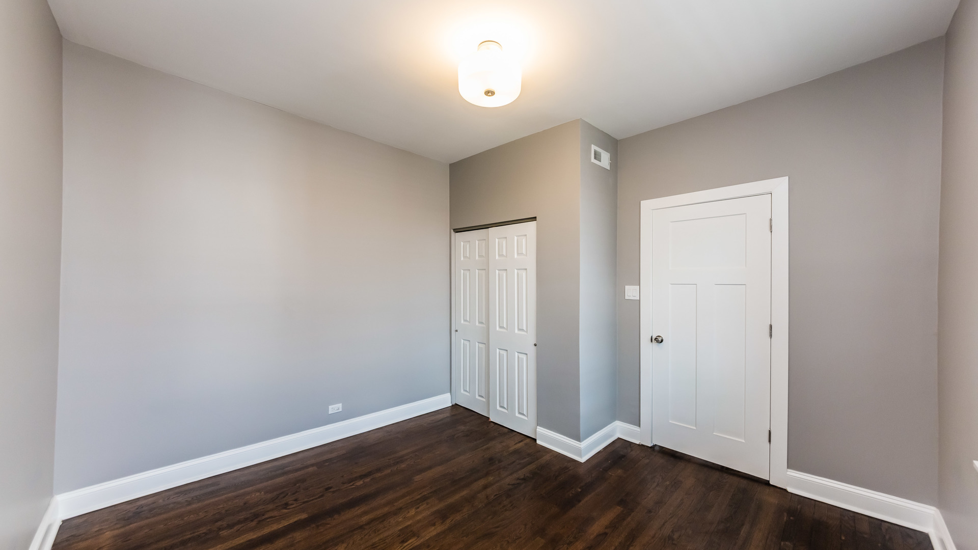3903 West Belden Avenue, Unit 2 Chicago, IL 60647 - Photo 13 of 15 an empty room with wooden floor and window
