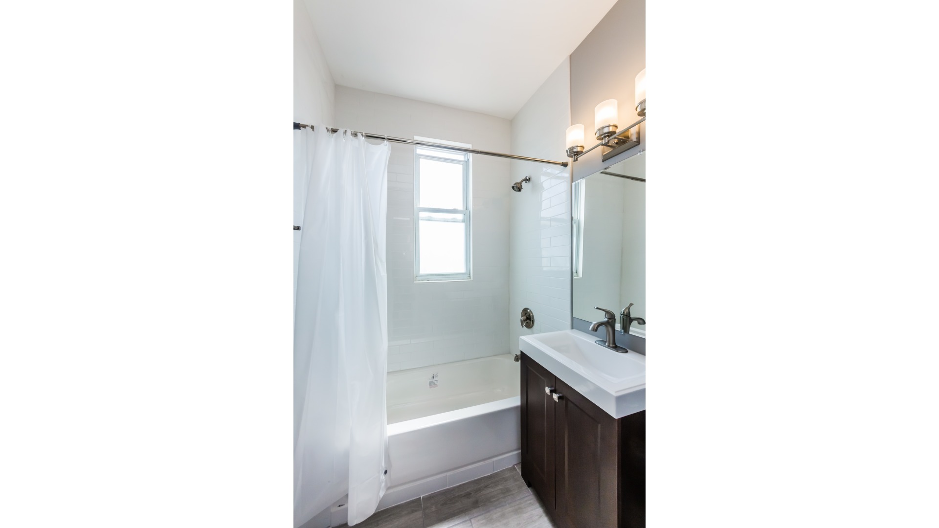 3903 West Belden Avenue, Unit 2 Chicago, IL 60647 - Photo 14 of 15 a bathroom with a sink a shower and a mirror