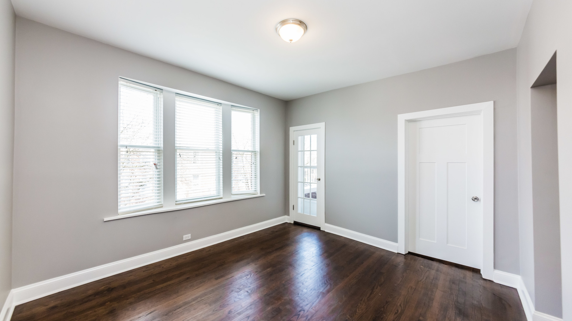 3903 West Belden Avenue, Unit 2 Chicago, IL 60647 - Photo 6 of 15 an empty room with wooden floor and windows