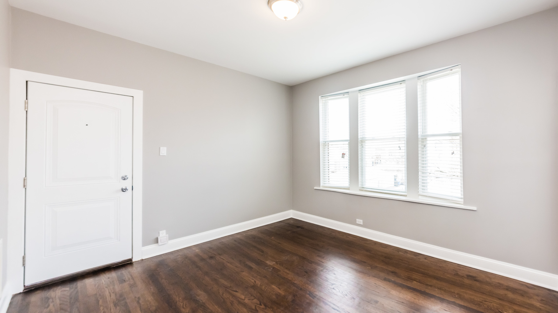 3903 West Belden Avenue, Unit 2 Chicago, IL 60647 - Photo 7 of 15 an empty room with wooden floor and windows