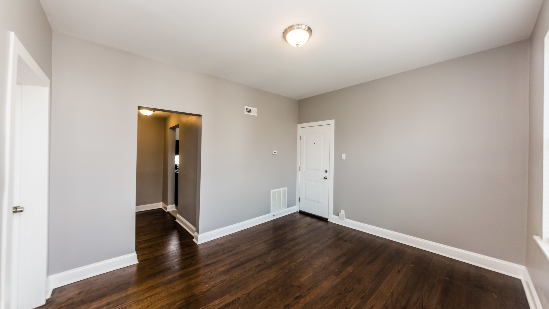 3903 West Belden Avenue, Unit 2 Chicago, IL 60647 - Photo 8 of 15 an empty room with wooden floor and entrance