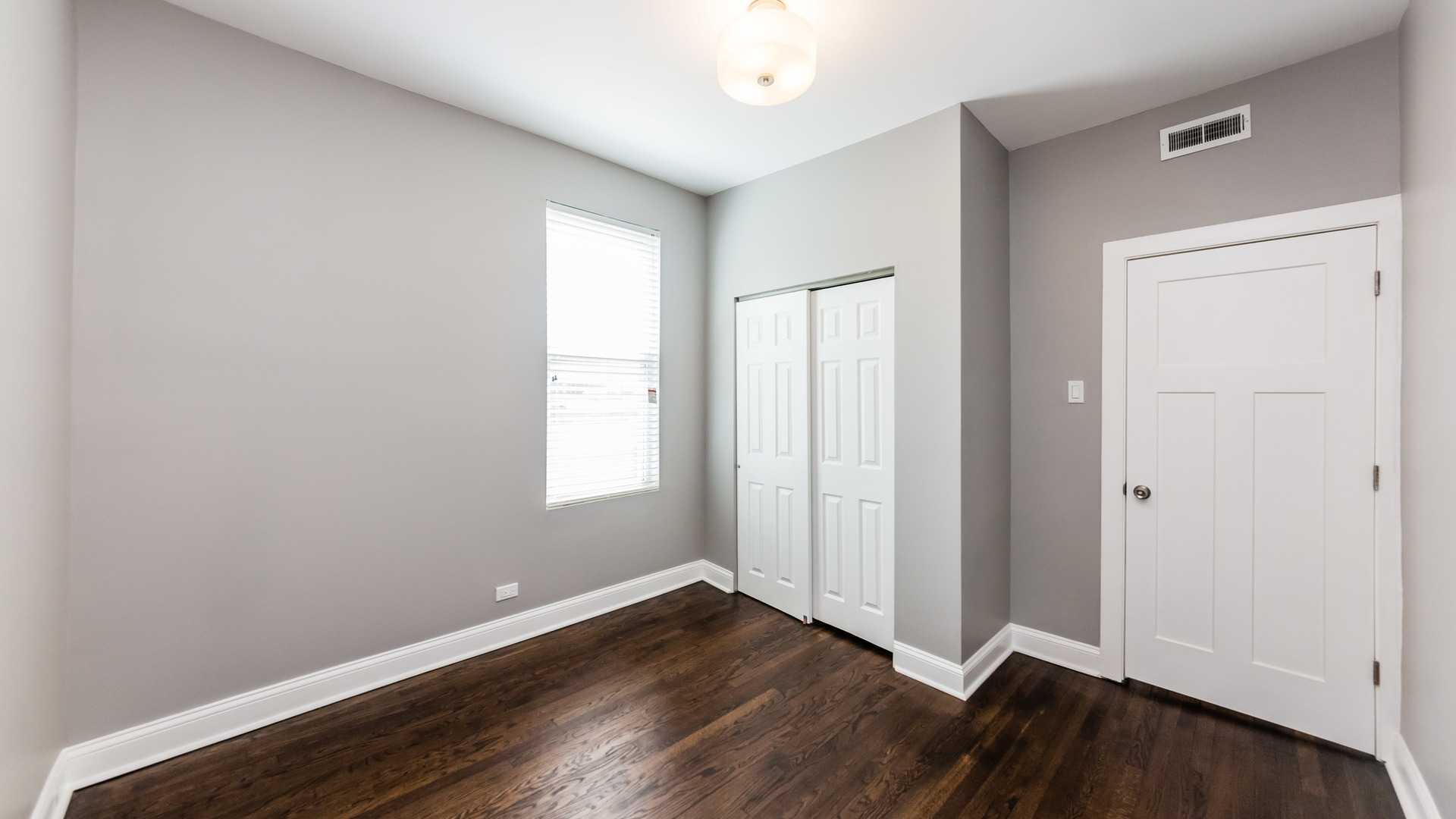3903 West Belden Avenue, Unit 2 Chicago, IL 60647 - Photo 9 of 15 an empty room with wooden floor and windows