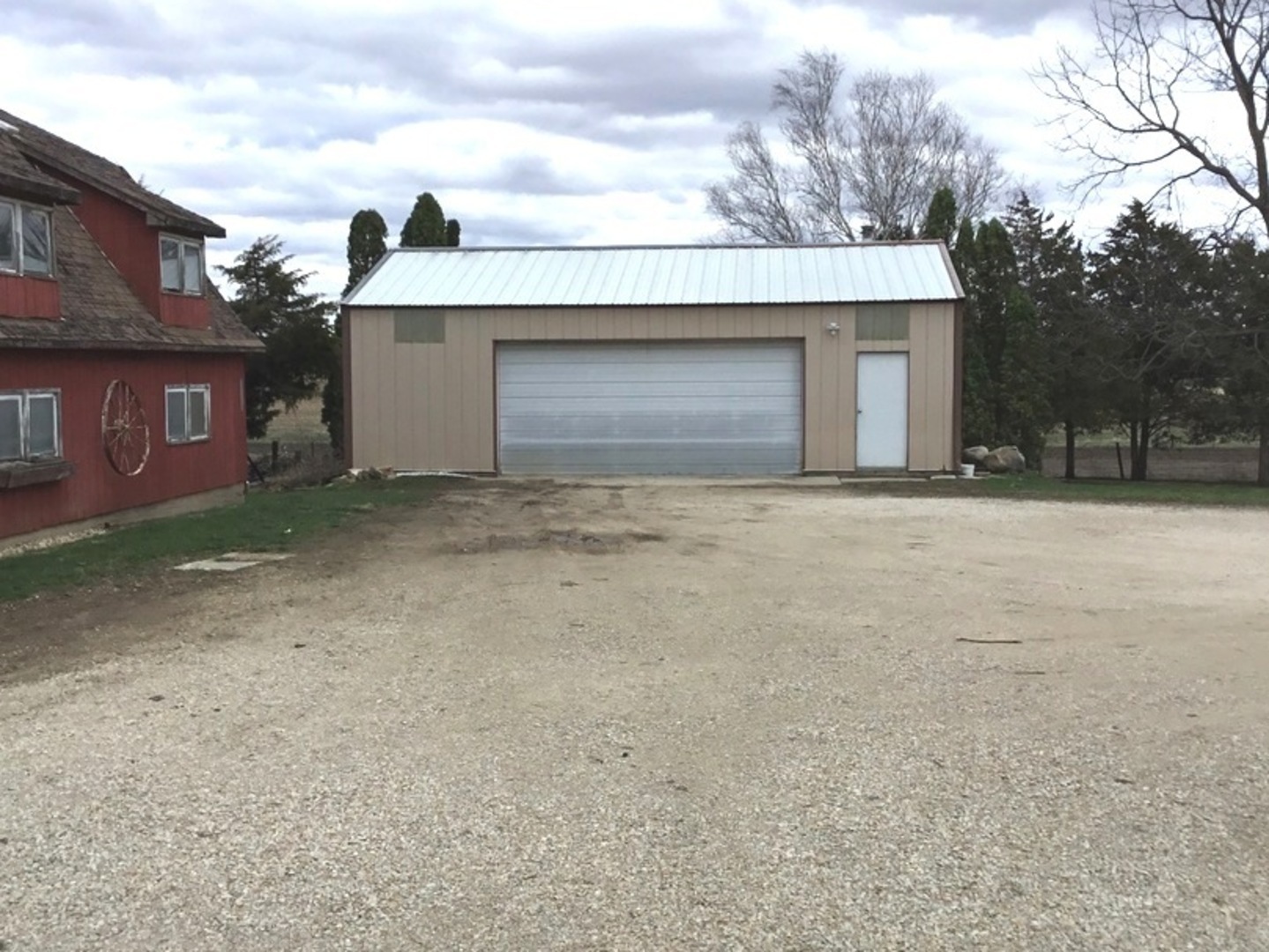 2437 Houghtby Road Shabbona, IL 60550 - Photo 22 of 29 a front view of a house with a yard and garage