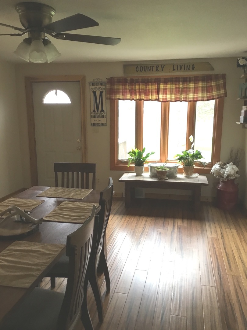 2437 Houghtby Road Shabbona, IL 60550 - Photo 8 of 29 a kitchen with a table chairs and wooden floor
