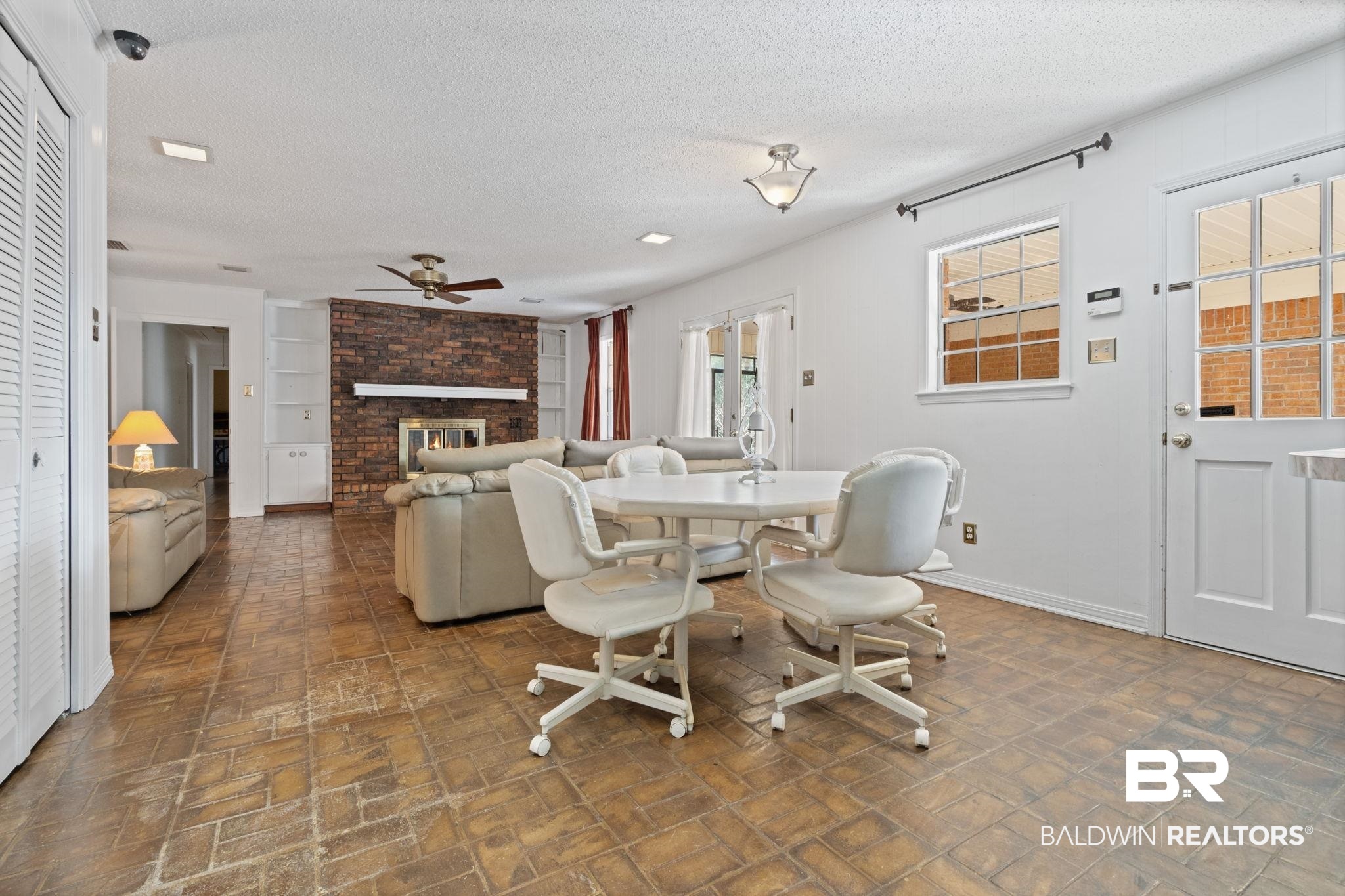 6261 Old Pascagoula Road Theodore, AL 36582 - Photo 15 of 29 Dining room featuring ceiling fan, a fireplace, and a textured ceiling
