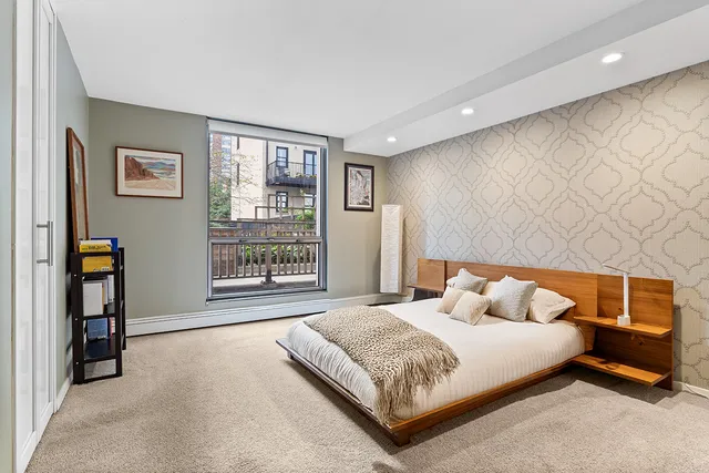 a bedroom with a large bed and a window