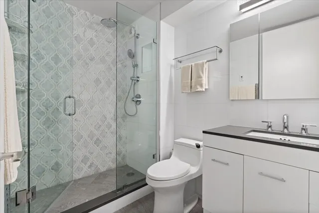 a bathroom with a sink toilet and shower