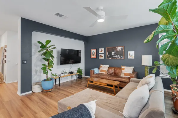 a living room with furniture and a potted plant