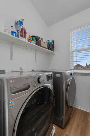 a bathroom with a double vanity sink toilet and shower