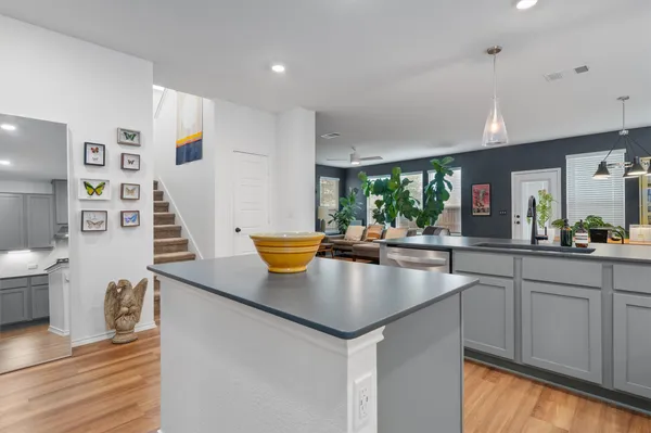 a kitchen with counter space and a view of living room