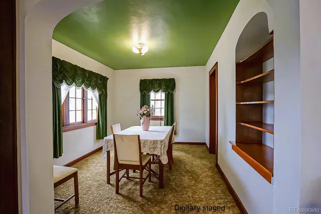 a dining room with furniture and window