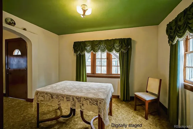 a view of a hallway with furniture and a window