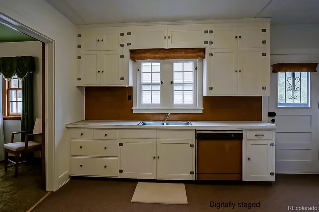 a kitchen with granite countertop white cabinets stainless steel appliances a sink and a window