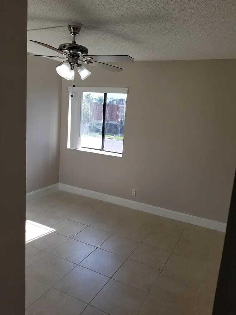 2184 White Pine Circle, Unit A Greenacres, FL 33415 - Photo 14 of 15 a view of an empty room with a window