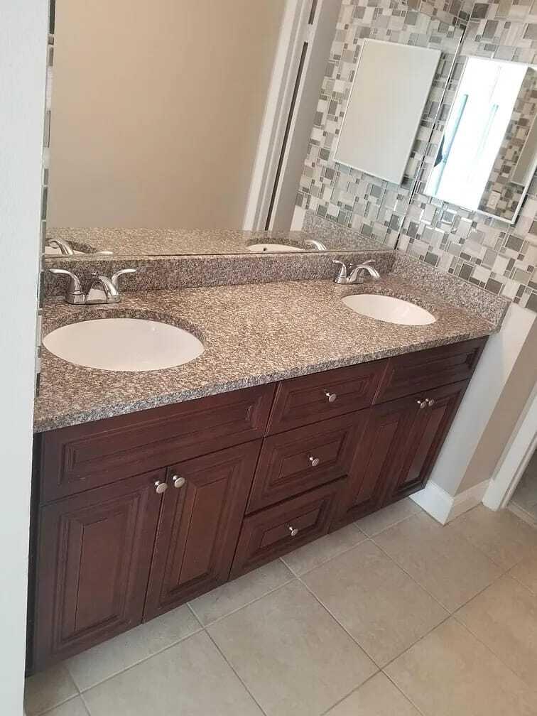 2184 White Pine Circle, Unit A Greenacres, FL 33415 - Photo 9 of 15 a bathroom with a granite countertop sink and a mirror