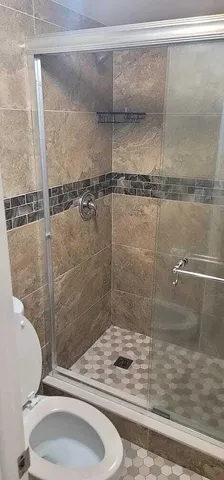 a bathroom with a sink toilet and shower
