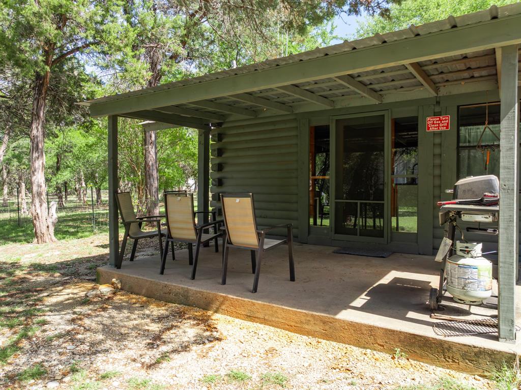 2731 Garrett Lane China Spring, TX 76633 - Photo 16 of 36 a view of a patio with table and chairs and floor to ceiling window