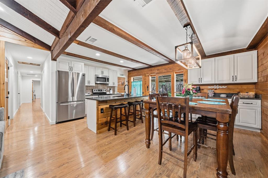 2731 Garrett Lane China Spring, TX 76633 - Photo 22 of 36 a view of a dining area with furniture and wooden floor