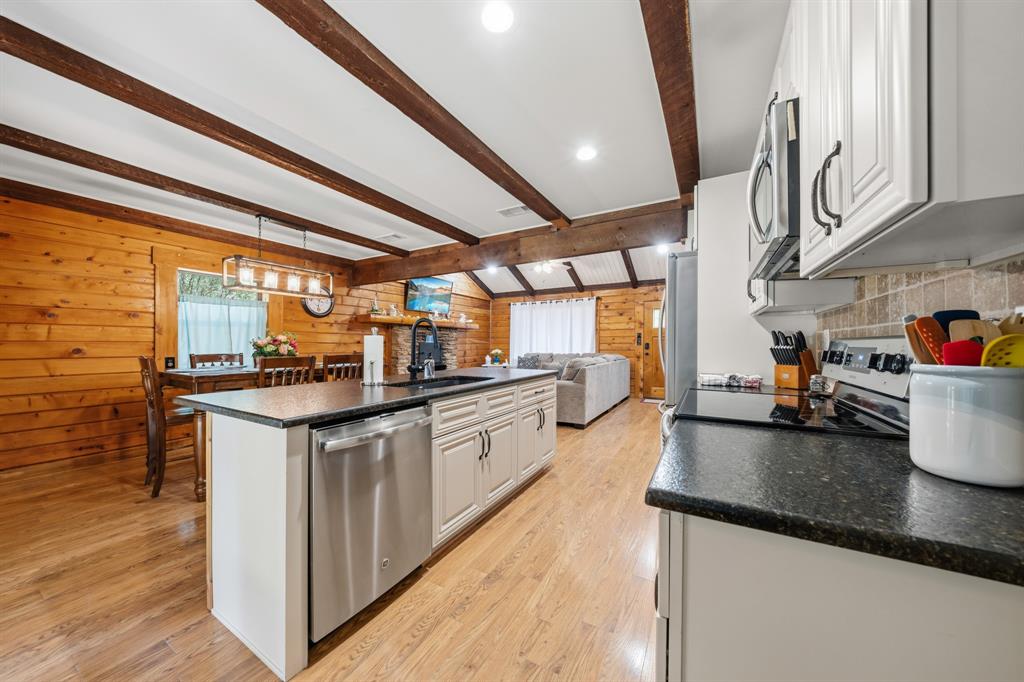 2731 Garrett Lane China Spring, TX 76633 - Photo 26 of 36 a kitchen with stainless steel appliances granite countertop a sink a stove and a wooden floors