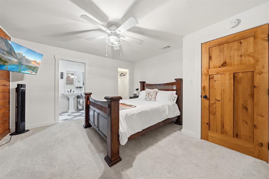 2731 Garrett Lane China Spring, TX 76633 - Photo 32 of 36 a bedroom with a bed and a chandelier