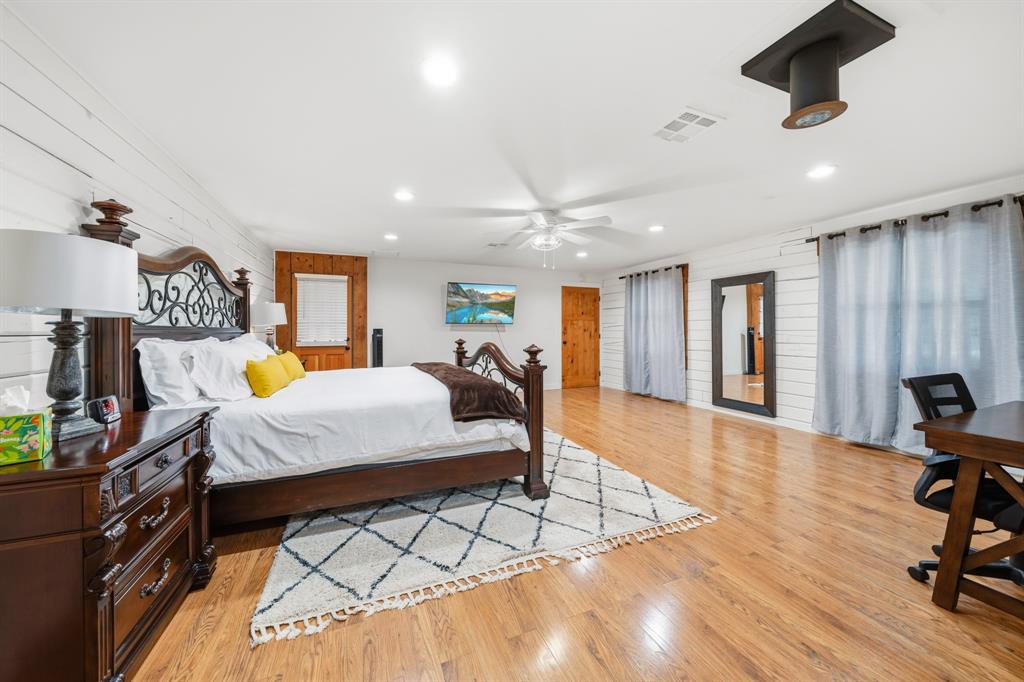 2731 Garrett Lane China Spring, TX 76633 - Photo 35 of 36 a bedroom with furniture and a wooden floor