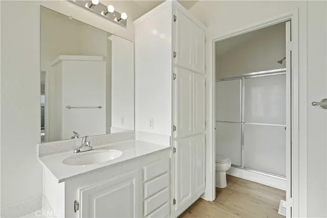 a bathroom with a double vanity sink mirror and toilet
