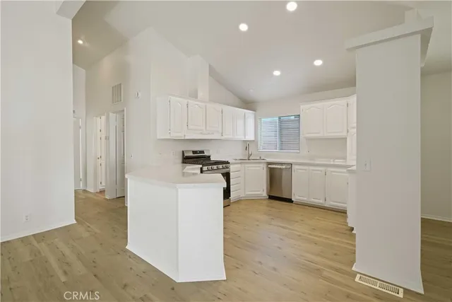 a kitchen with cabinets and stainless steel appliances