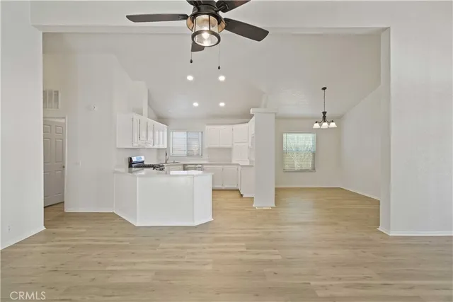 a view of a kitchen with a refrigerator and microwave